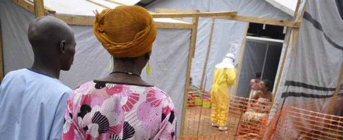 Eine Patientin wird gleich nach ihrer Ankunft in dem von Ärzte ohne Grenzen betreuten Ebola-Behandlungszentrum von einer Krankenschwester empfangen.