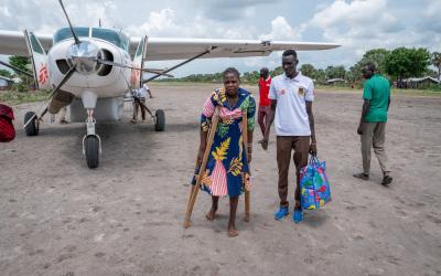 South Sudan: Patient in front of a plane