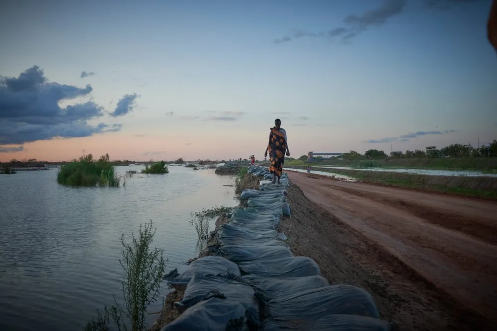 Woman walking along a dyke