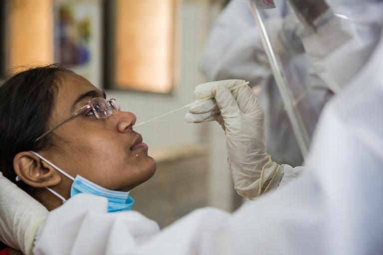 Dr sharanya in the fever clinic taking a sample.jpg