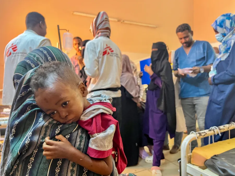 Mother hugging little Munir (3yo)