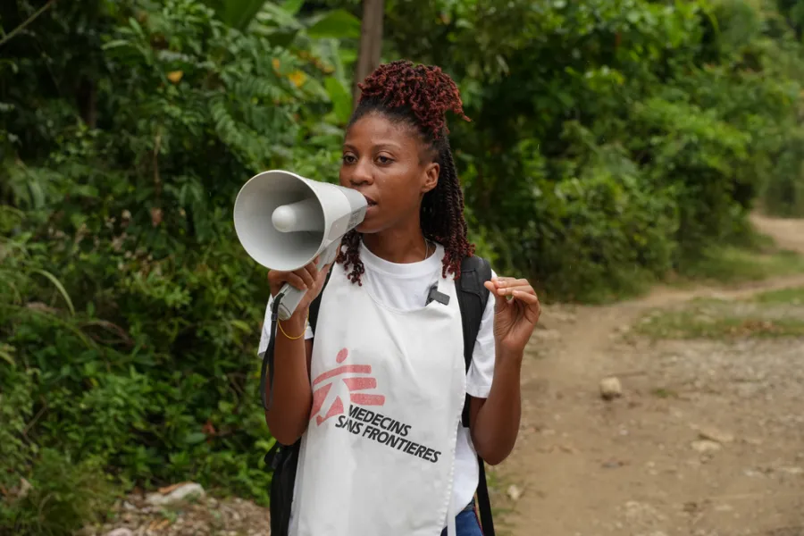 Health promoter talks to residents of Calebasse, a remote village in southern Haiti