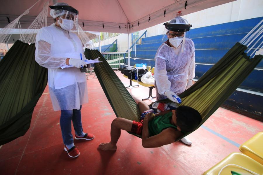 Health team takes the temperature of an indigenous Warao man in an isolation and observation center for people with mild cases of COVID-19 Health team takes the temperature of an indigenous Warao man in an isolation and observation center for people with mild cases of COVID-19