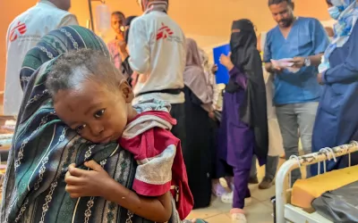 Mother hugging little Munir (3yo)