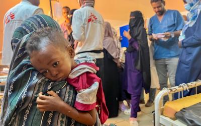 Mother hugging little Munir (3yo)