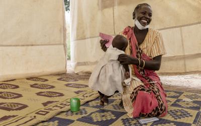 Ateny Mayen Akoi holds her eight-month-old daughter at a distribution site set up in the village of Kuom, South Sudan