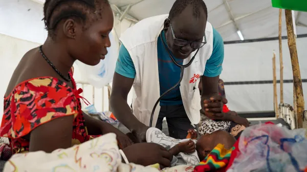 Dr Ran Jal kuol examines a child admitted to the measles isolation ward
