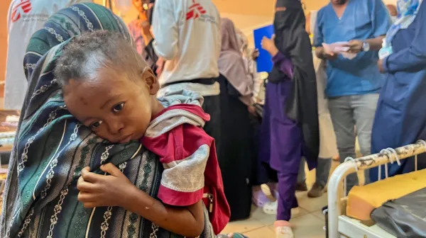 Mother hugging little Munir (3yo)