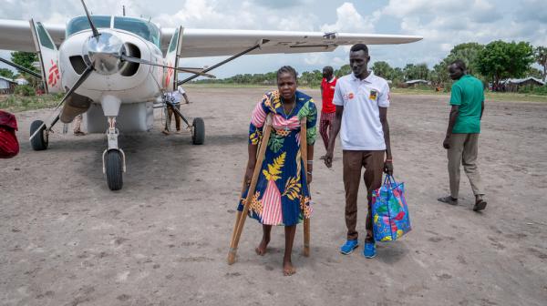 South Sudan: Patient in front of a plane