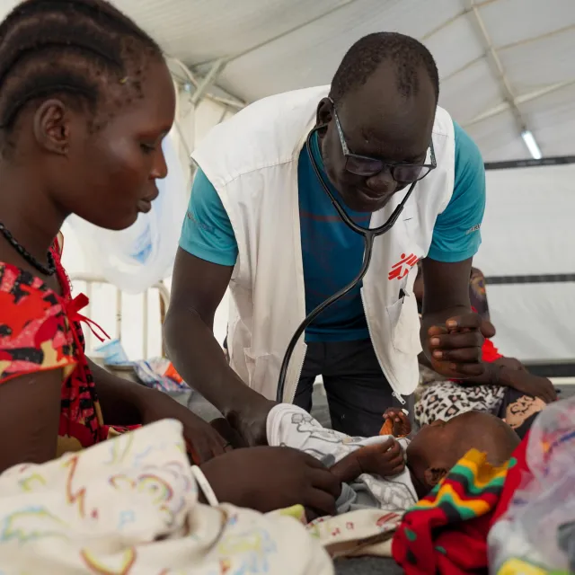 Dr Ran Jal kuol examines a child admitted to the measles isolation ward